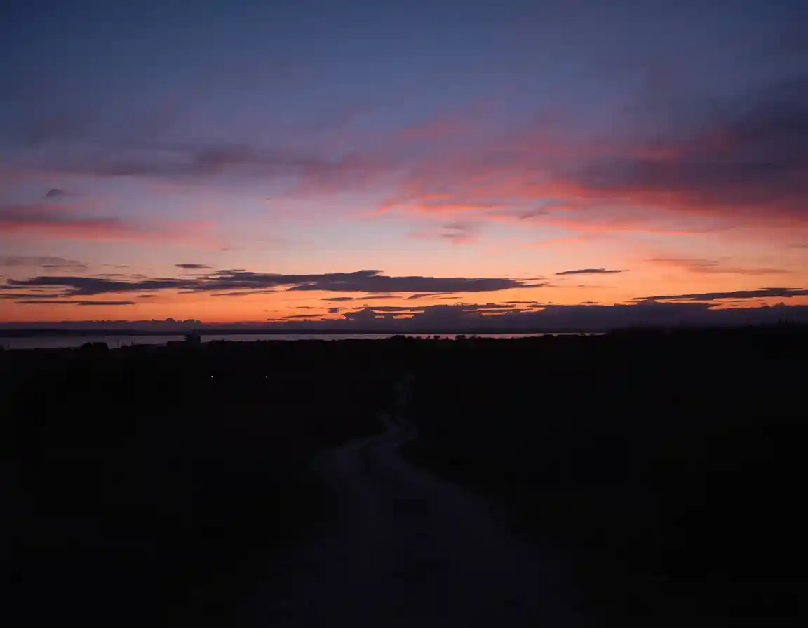 Evening skyline with soft twilight colours and a winding pathway below